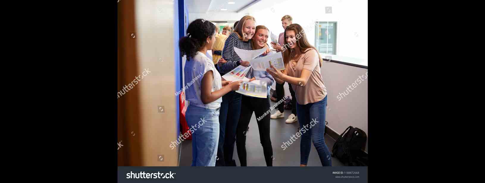 Stock Photo Excited Teenage High School Students Celebrating Exam Results In School Corridor 1188872668